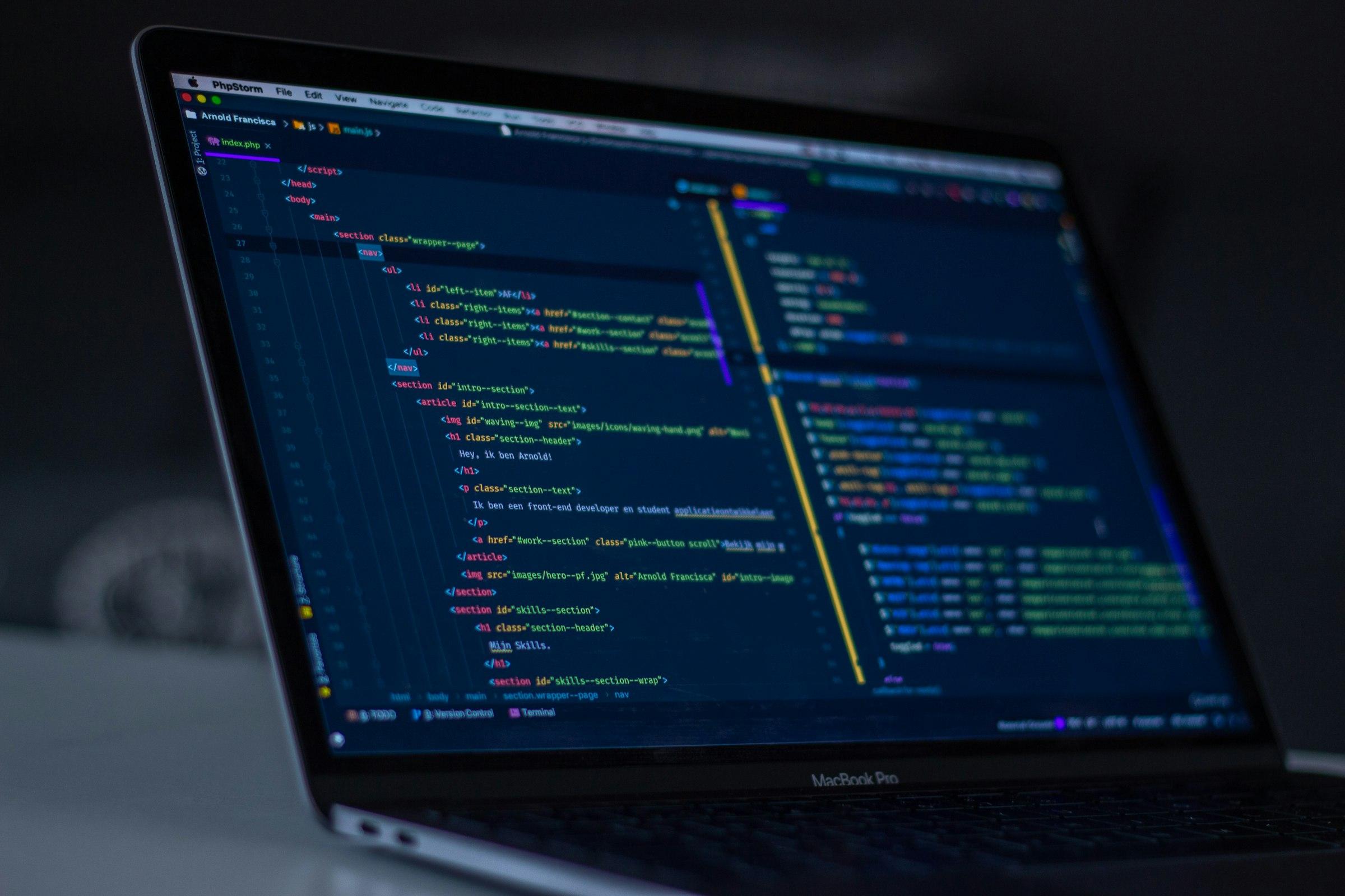 Source code open in a dark editor on a laptop