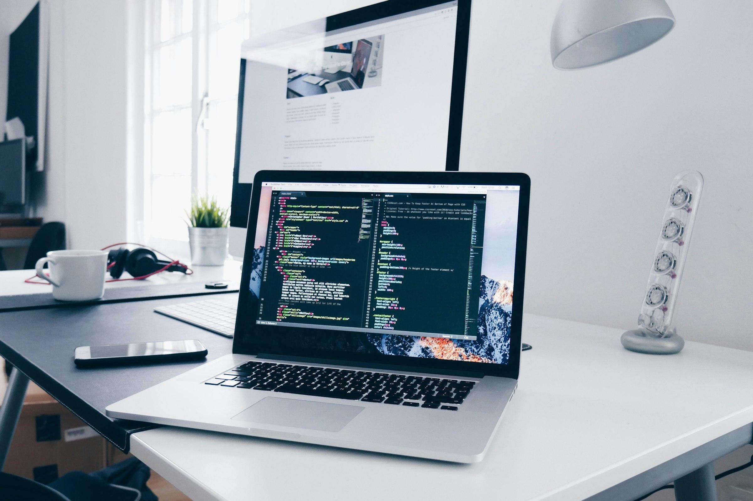 Bright product workspace with a laptop, notes and design references